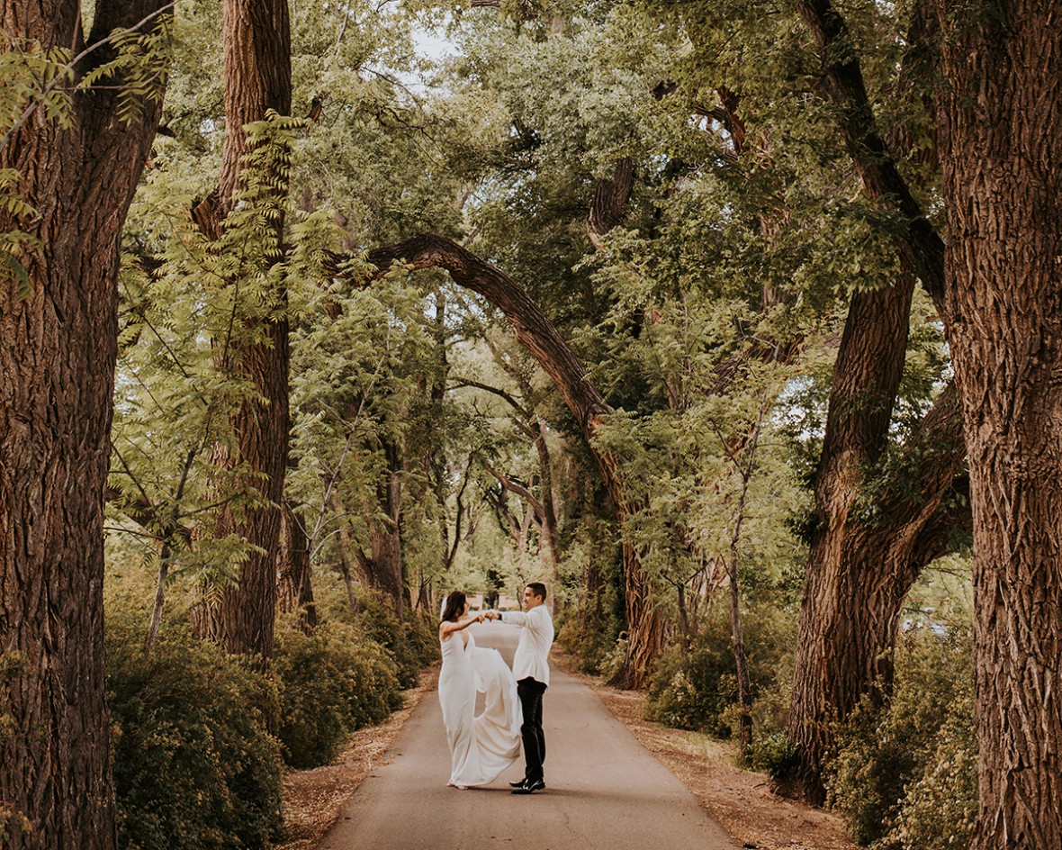 Wedding couple in the cottonwood driveway in summertime