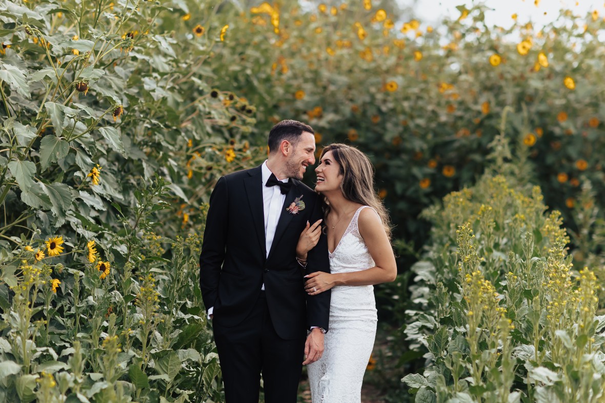 Bride and Groom surrounded by sunflowers