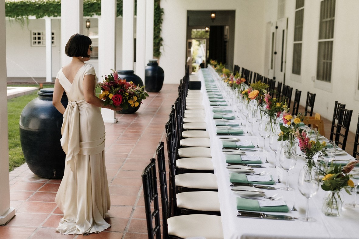 A bride on La Quinta Portal with a long table set for a wedding dinner