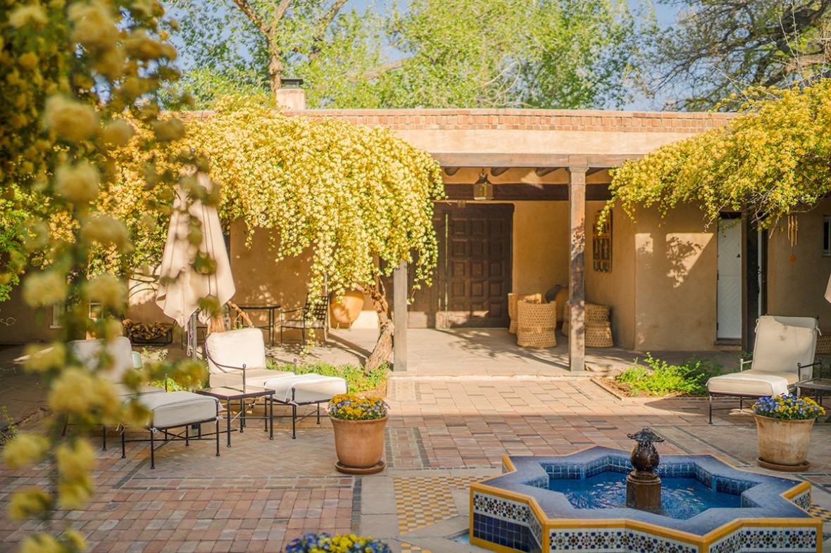 view of the hacienda spa courtyard with blooming lady banks rose