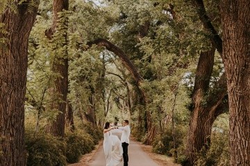 Wedding couple in the cottonwood driveway in summertime