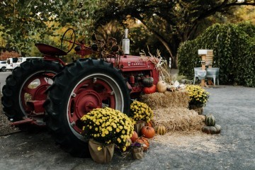old red tractor decorated with fall decor