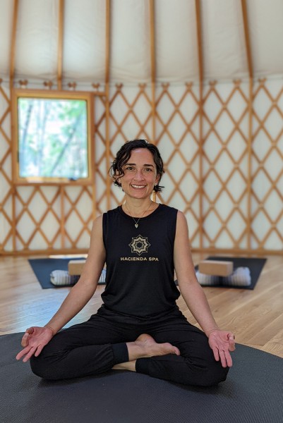 meditation instructor posing in yurt